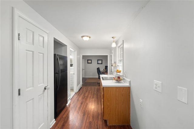 hallway featuring sink and dark hardwood / wood-style flooring