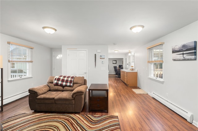 living room with light hardwood / wood-style flooring, a healthy amount of sunlight, and a baseboard radiator