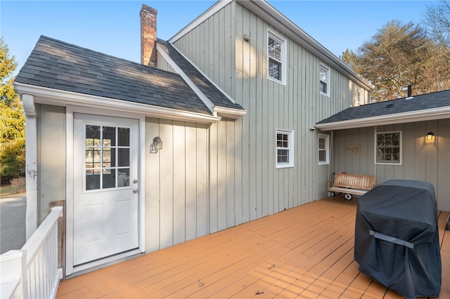 rear view of property featuring a wooden deck