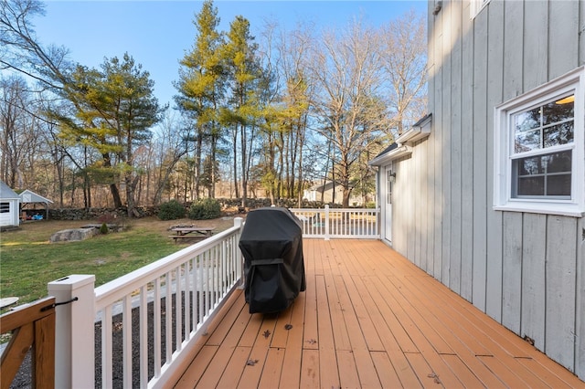 deck featuring a grill and a yard