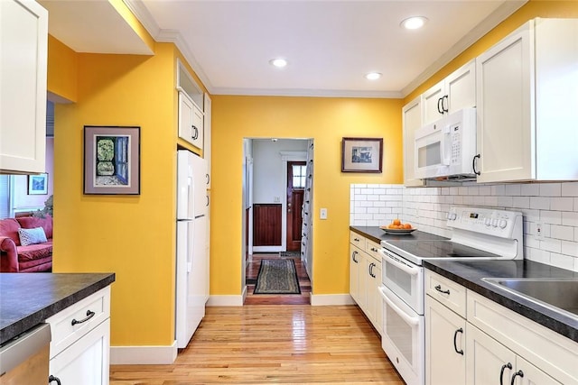 kitchen featuring white cabinetry, light hardwood / wood-style floors, tasteful backsplash, white appliances, and crown molding