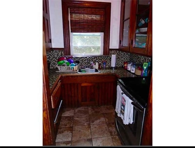 kitchen with sink, backsplash, and range with electric stovetop