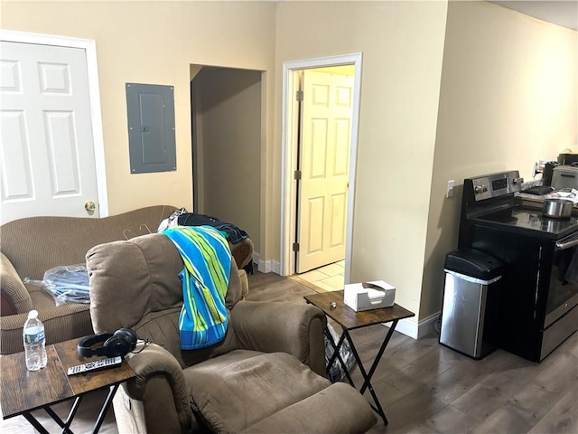 living room featuring dark wood-type flooring, washer / dryer, and electric panel