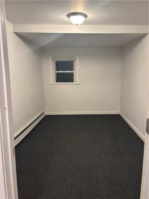 unfurnished room with a baseboard heating unit and carpet flooring