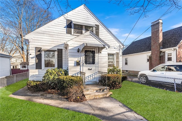 bungalow-style home featuring a front lawn