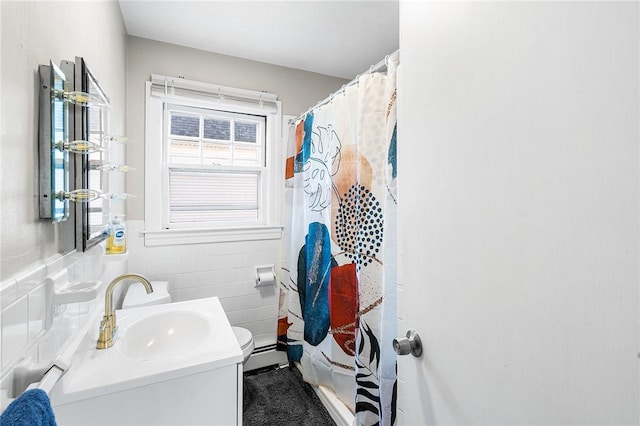 bathroom with vanity, toilet, tile walls, and a shower with shower curtain