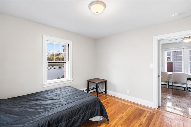 bedroom featuring hardwood / wood-style flooring and a baseboard radiator