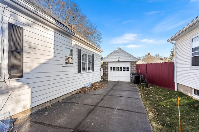 view of property exterior featuring a garage and an outdoor structure