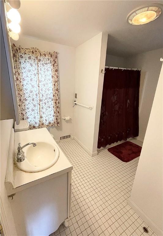 bathroom with tile patterned floors and vanity