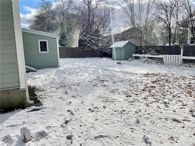 snowy yard with a storage unit