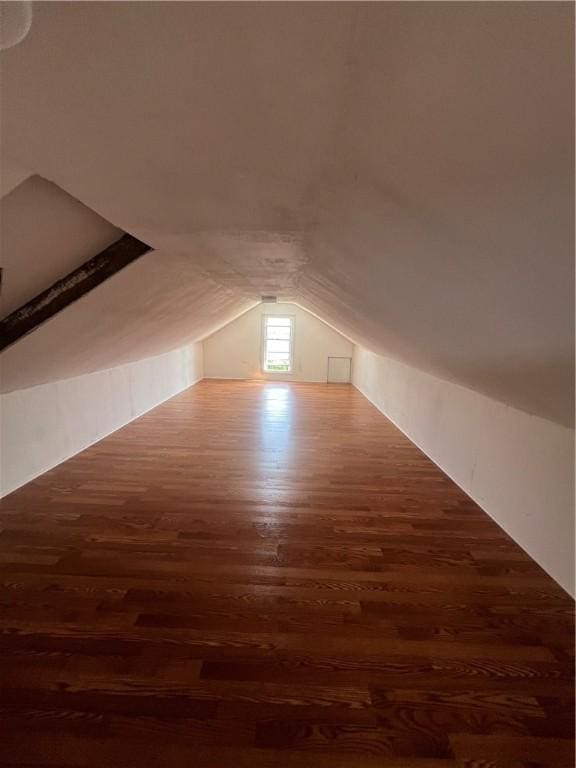 additional living space featuring dark hardwood / wood-style floors and vaulted ceiling