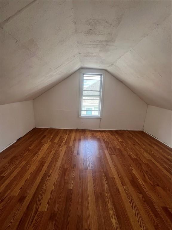 bonus room with vaulted ceiling and hardwood / wood-style floors