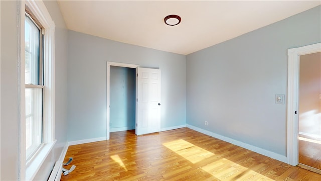 unfurnished bedroom with light wood-type flooring