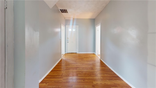 corridor with wood-type flooring