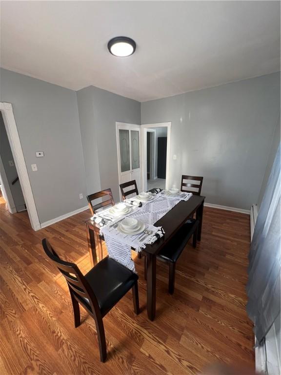 dining space featuring hardwood / wood-style flooring and baseboard heating