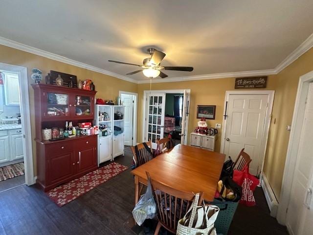 dining area with crown molding, a baseboard heating unit, dark wood-type flooring, and ceiling fan