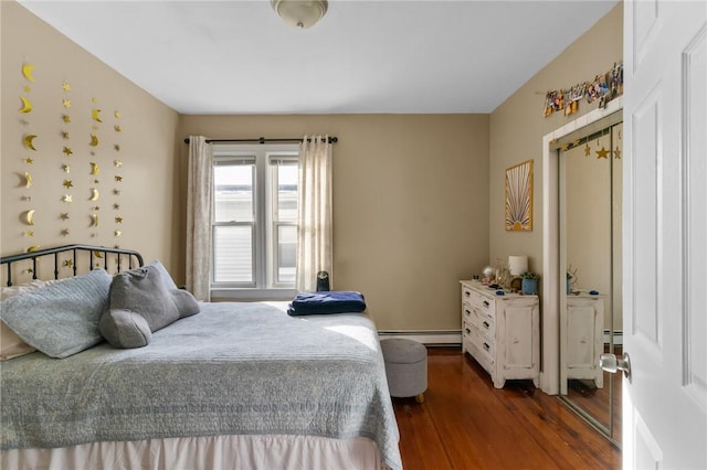 bedroom featuring dark wood-type flooring and baseboard heating