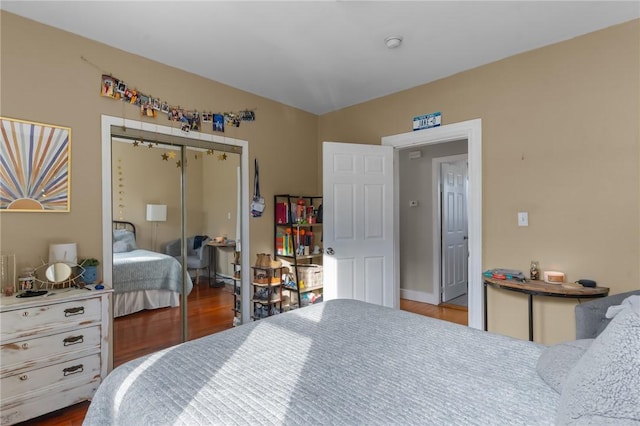 bedroom with a closet and dark hardwood / wood-style floors