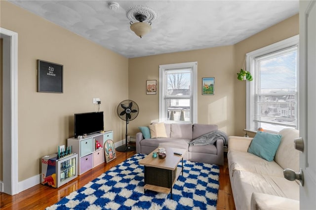 living room with plenty of natural light and hardwood / wood-style flooring