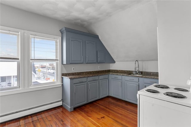 kitchen featuring lofted ceiling, a baseboard heating unit, hardwood / wood-style floors, sink, and white electric range oven