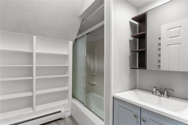 bathroom featuring vanity, vaulted ceiling, a textured ceiling, shower / bath combination with glass door, and a baseboard radiator