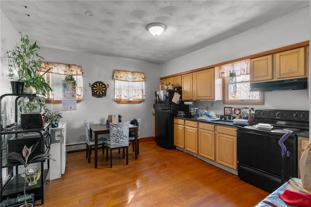 kitchen with black appliances, a baseboard radiator, and light hardwood / wood-style floors