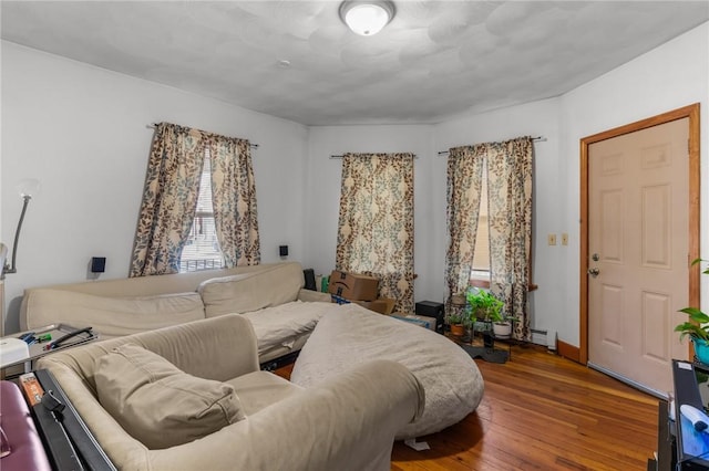 bedroom featuring a baseboard radiator and hardwood / wood-style flooring