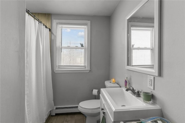 bathroom featuring toilet, a baseboard heating unit, plenty of natural light, and curtained shower