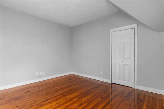 additional living space featuring hardwood / wood-style floors and lofted ceiling