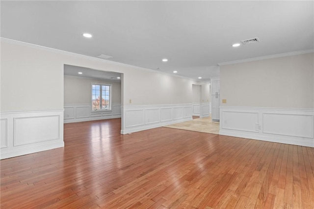 unfurnished room featuring crown molding and light hardwood / wood-style floors