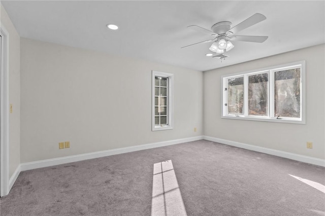 carpeted spare room with ceiling fan