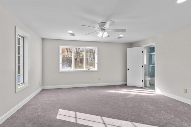 carpeted spare room with ceiling fan