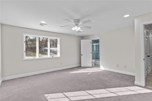 unfurnished bedroom featuring ceiling fan, connected bathroom, and light colored carpet