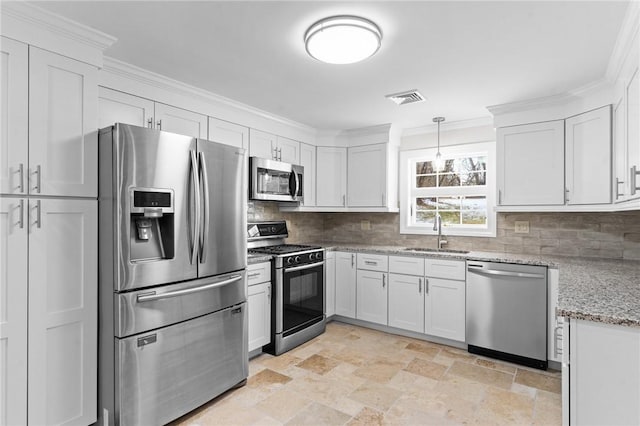 kitchen featuring light stone countertops, sink, stainless steel appliances, and white cabinetry