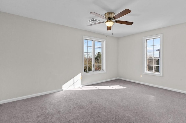 carpeted empty room featuring ceiling fan and a healthy amount of sunlight