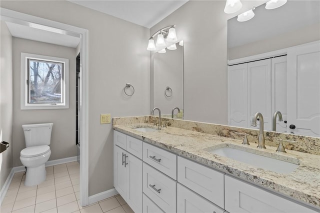 bathroom with toilet, tile patterned floors, and vanity