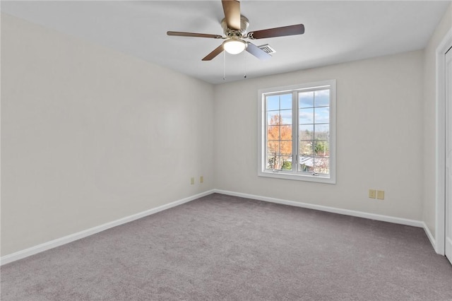 spare room with ceiling fan and carpet flooring