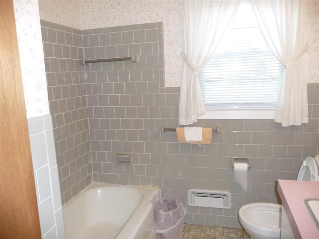 bathroom featuring a washtub, tile walls, toilet, and vanity