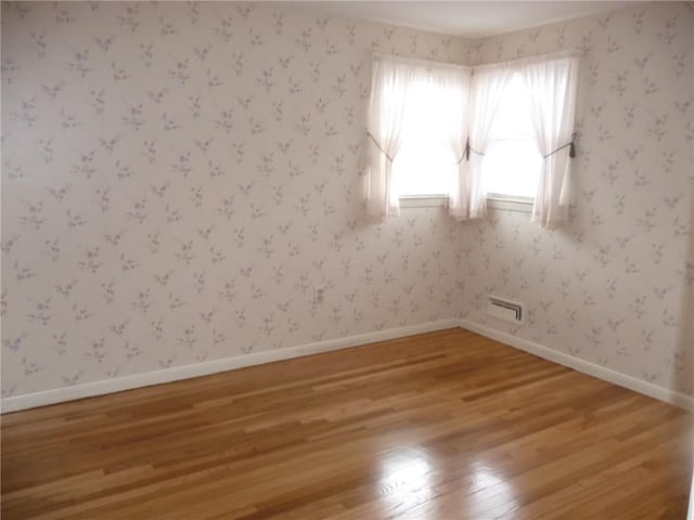 empty room with hardwood / wood-style flooring