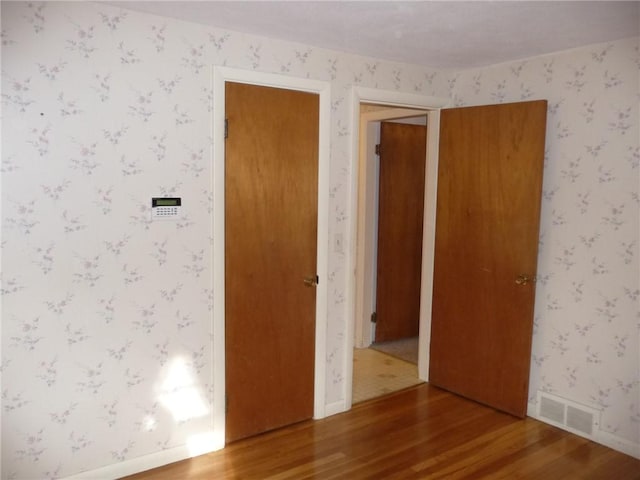 spare room with hardwood / wood-style floors