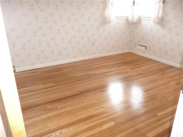 spare room with light wood-type flooring