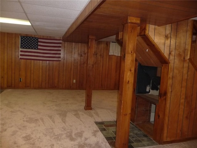 additional living space with wooden walls and carpet floors