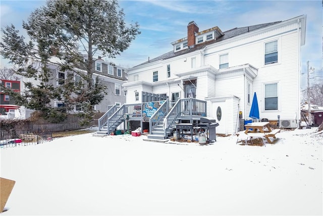 snow covered house with ac unit