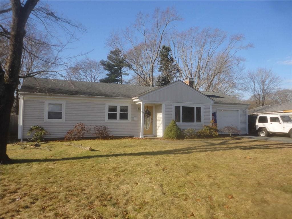 single story home with a garage and a front yard