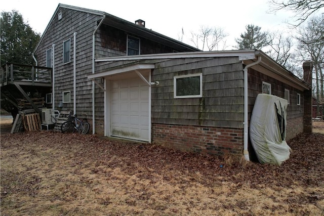 view of side of property featuring a garage and ac unit