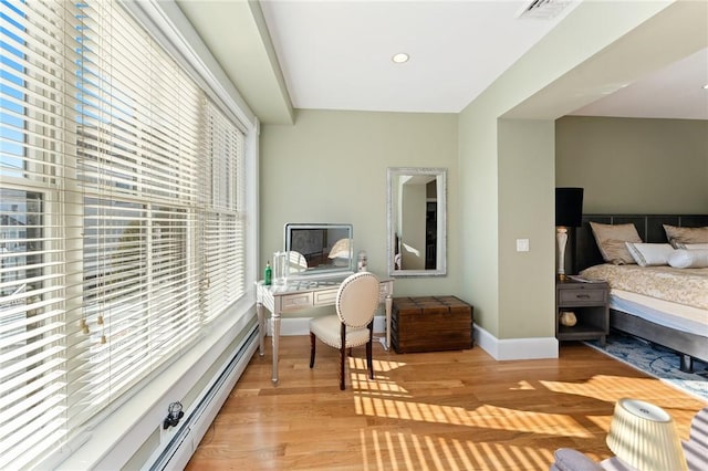 bedroom with light hardwood / wood-style floors and multiple windows