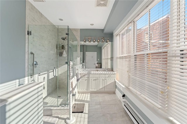 bathroom featuring a shower with shower door, baseboard heating, and vanity