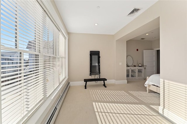 carpeted bedroom with a baseboard radiator