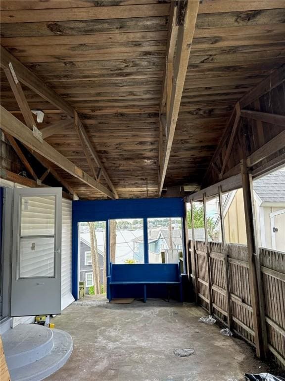 unfurnished sunroom featuring vaulted ceiling