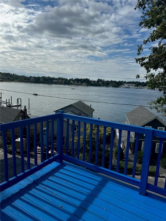 wooden deck featuring a water view